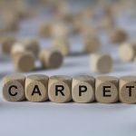 Carpet spelled out with wooden blocks