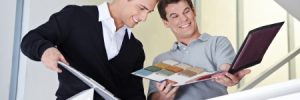 Men Looking at a book of Commercial Carpeting Samples