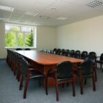 Carpet in conference room with wood table and chairs