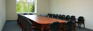 Carpet in conference room with wood table and chairs