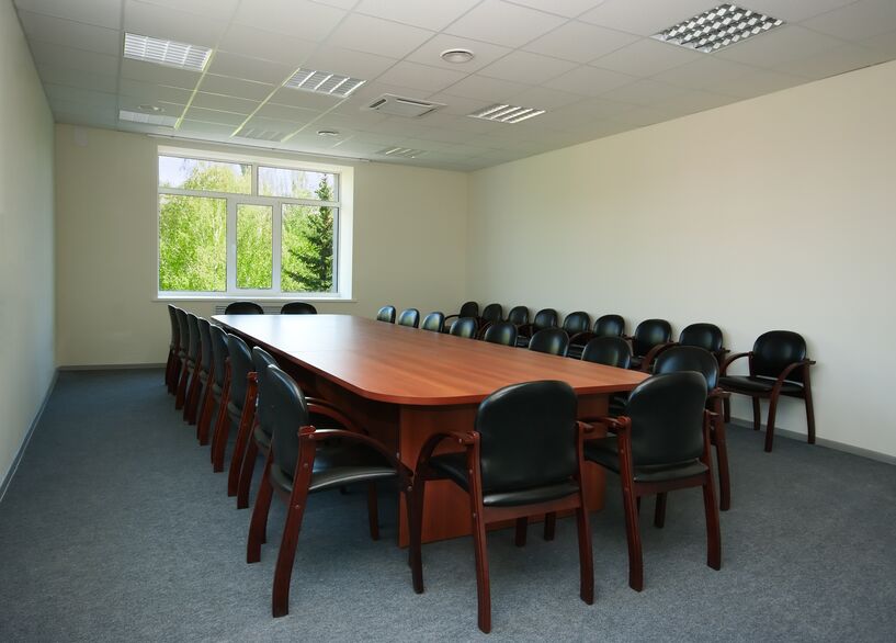 Carpet in conference room with wood table and chairs