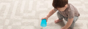 Child spilling drink on new carpet