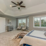 Bedroom with tan carpeting