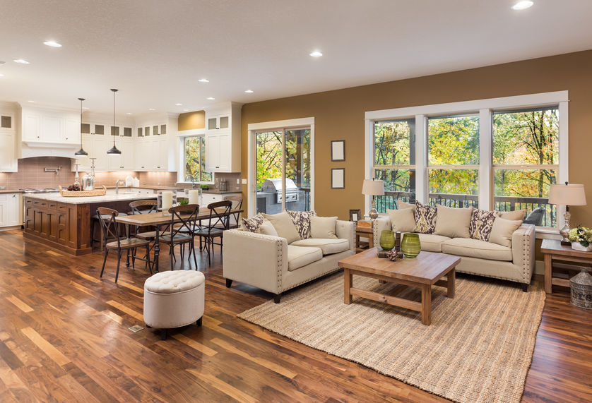 Hardwood flooring spanning from kitchen to living room in open concept home