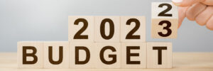 wooden blocks, the bottom row sells "budget" and on top there is "2023"