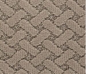 Close-up of beige carpet with a raised, interlocking geometric weave pattern.