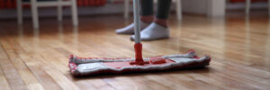 Woman using mop cleaner to maintain hardwood floors