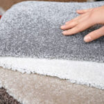 Woman touching carpet samples at a discount carpeting store