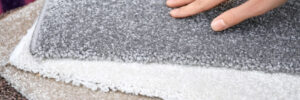 Woman touching carpet samples at a discount carpeting store