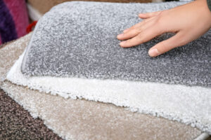 Woman touching carpet samples at a discount carpeting store