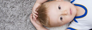cute baby lying on back on carpet